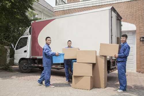 Local movers loading household items into a removal van